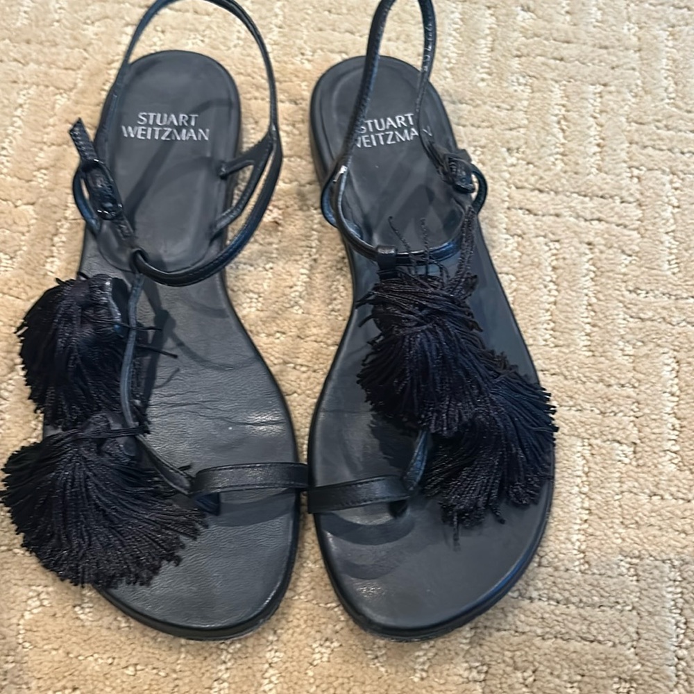 Stuart Weitzman black leather flat sandal with tassel detail
